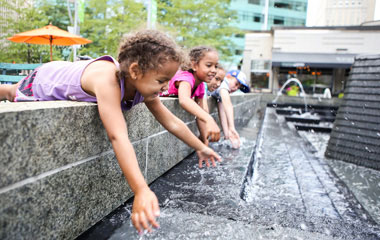 Children playing in outdoor water feature